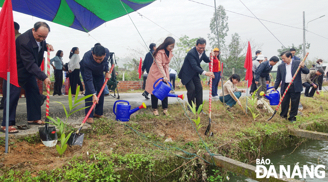 Lãnh đạo Ủy ban MTTQ Việt Nam thành phố, Ban Dân vận Thành ủy, Hội Nông dân thành phố và Huyện ủy Hòa Vang trồng cây trên tuyến đường liên thôn ở thôn 5, xã Hòa Khương, huyện Hòa Vang. Ảnh: H.H