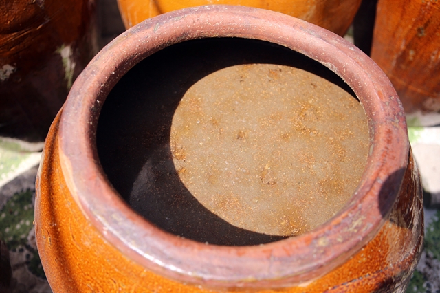 TRADITIONAL PROCESSING: Anchovy is fermented by salt in a terracotta jar. The fish sauce trade of Nam Ô Village in Đà Nẵng was recognised as the National Intangible Heritage by the Ministry of Culture, Sports and Tourism. VNS Photo Le Lam