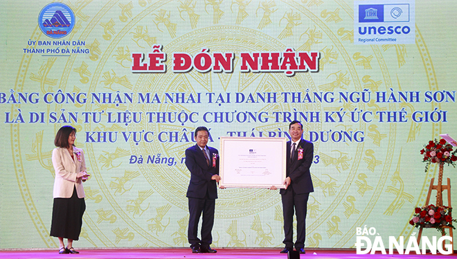 Deputy Minister of Culture, Sports and Tourism Hoang Dao Cuong (2nd, right) awarded a certificate recognising ‘ma nhai’ (Inscriptions) as a documentary heritage under the UNESCO Memory of the World for the Asia-Pacific Region Programme to Da Nang People's Committee Chairman Le Trung Chinh. Photo: XUAN DUNG