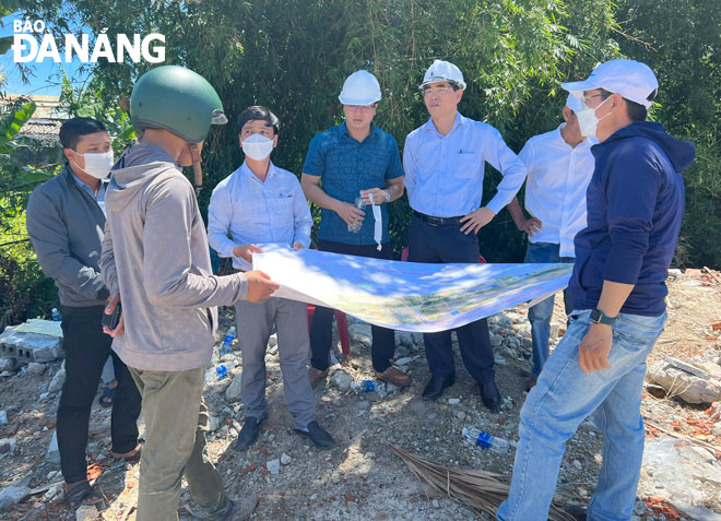 Lãnh đạo huyện Hòa Vang trao đổi với đại diện người dân tại dự án Tuyến đường vành đai phía tây 2 để đi đến thống nhất công tác đền bù, giải tỏa. Ảnh: T.Y