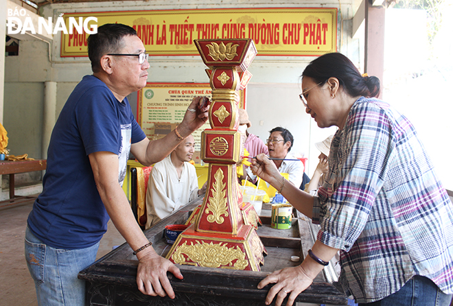 A decoration team rushes to repaint and repair lampstands and other works in preparation for the festival.