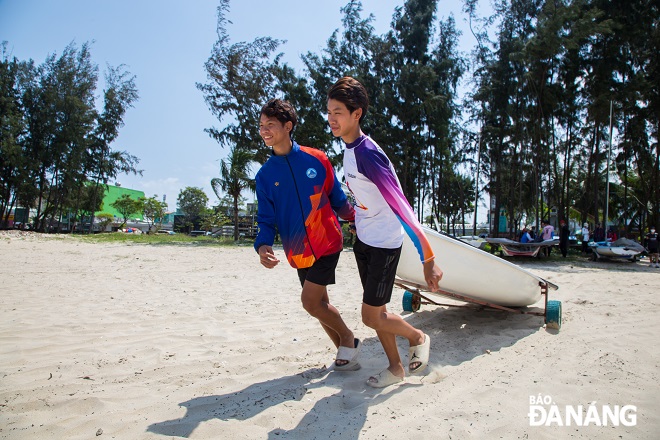 Athletes get boats into water in order to prepare for training