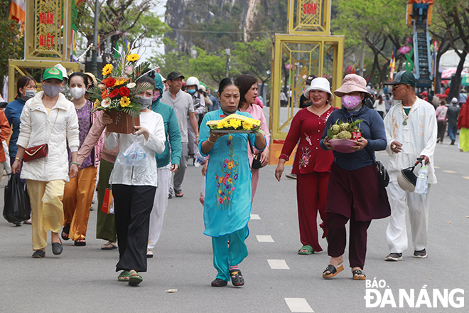 Buddhist followers bring offerings to the pagoda