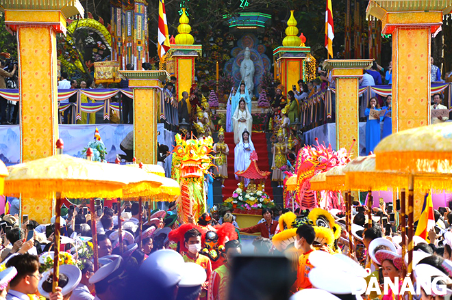 Residents, tourists, and Buddhist monks, nuns and followers stand in two rows to welcome the process of Bodhisattva Avalokitesvara Statue .