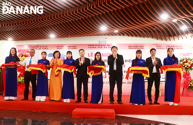 Secretary Quang (6th, left) and delegates cut the ribbon to open the photo exhibition entitled 