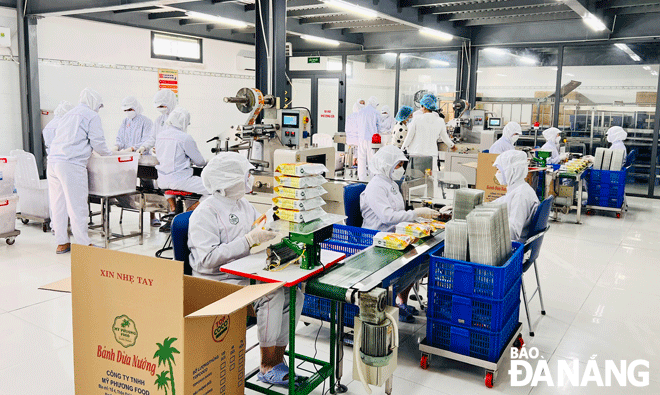 Enterprises are gearing up increasing production and seeking more consumption opportunities from the domestic market in the context of the volatile global economy. Workers are pictured at the My Phuong Food Co., Ltd in Hoa Vang District. Photo: M.Q