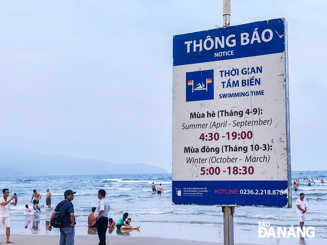 The notice of swimming times is placed at a beach