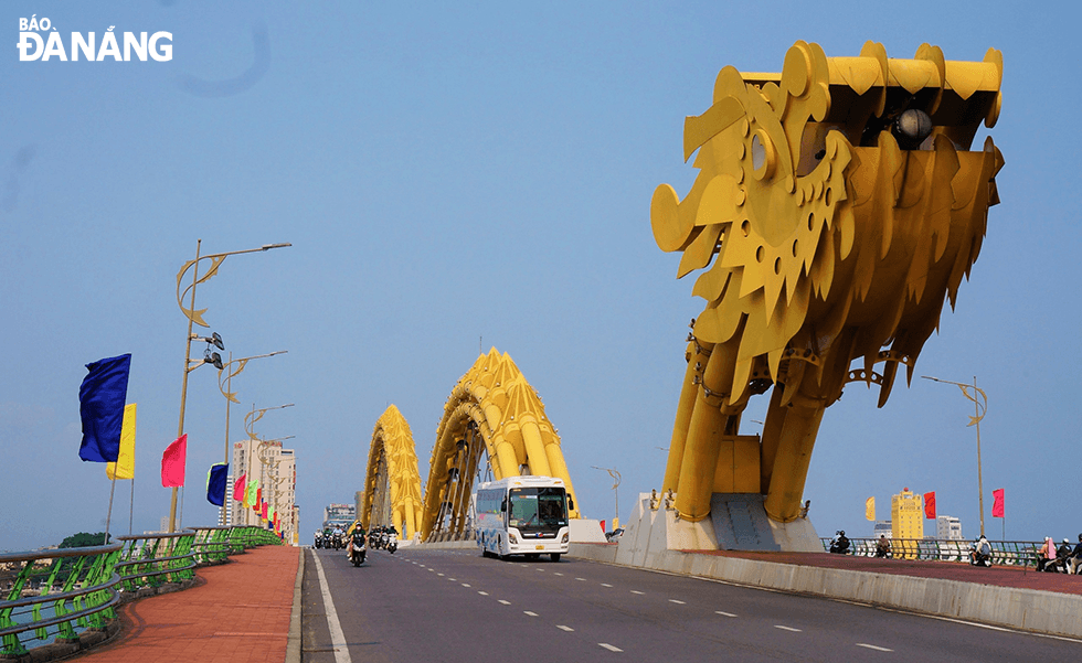 Colourful flags are hung along the Rong (Dragon) Bridge