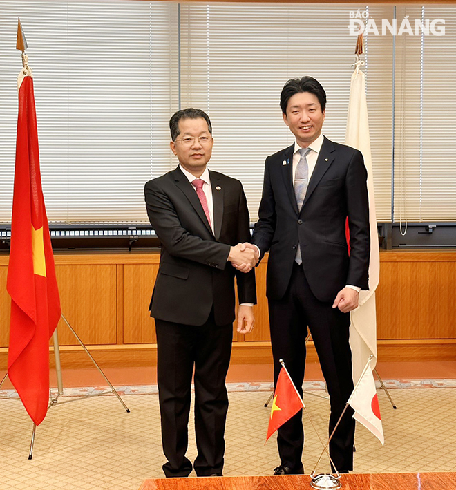 Bí thư Thành ủy Nguyễn Văn Quảng (trái) bắt tay chúc mừng Thị trưởng thành phố Sakai Nagafui Hideki.   