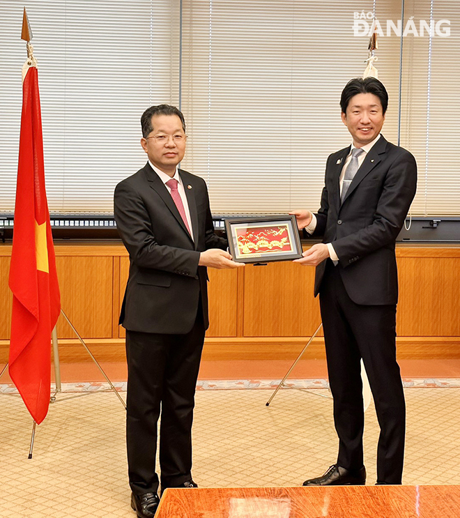 Da Nang Party Committee Secretary Nguyen Van Quang (left) preventing a souvenir gift to Mayor of Sakai City Nagafuji Hideki.