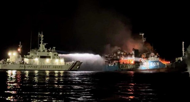 A Philippine Coast Guard ship trains its hose as it tries to extinguish fire on the MV Lady Mary Joy at Basilan, southern Philippines early March 30, 2023. (Photo: manisteenews.com)