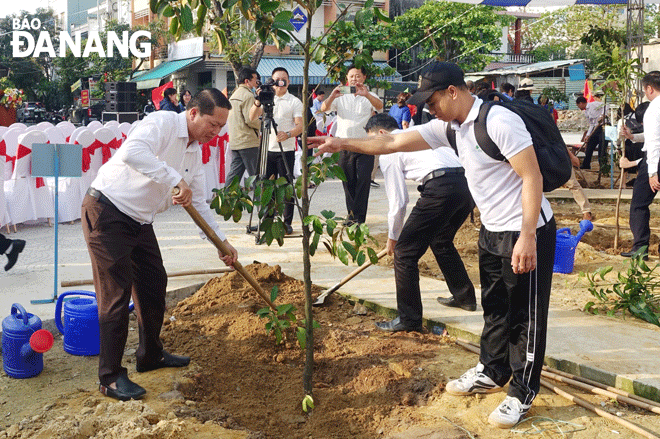 Đại diện lãnh đạo quân Sơn Trà (bên trái) trồng cây xanh ở công viên vườn dạo đường Phan Huy Chú. Ảnh: T.H