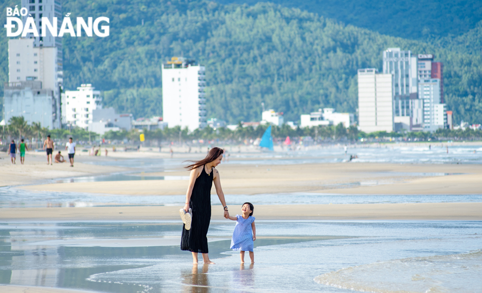 A mother and her daughter have fun at a beach