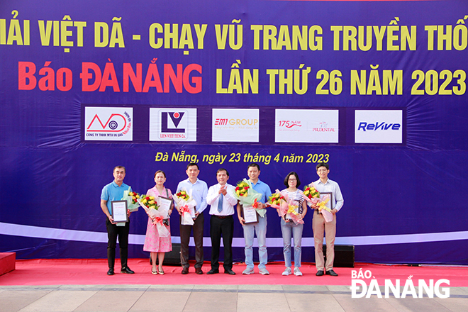 Mr Nguyen Duc Nam (middle) presented flowers sponsors