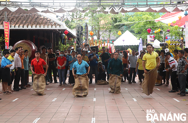 Contestants in a sack jumping relay race