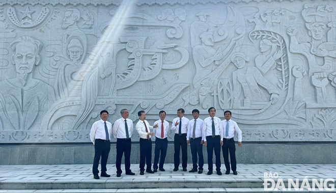 Current and former city leaders discussed in front of the bas-relief 