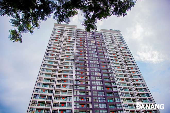 The brilliant scene of red flags with yellow stars at an apartment building in Da Nang