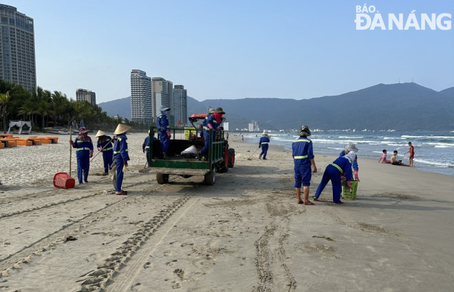 Sanitation workers from the Marine Environment Enterprise and motor vehicles quietly clean a beach opposite the East Sea Park.