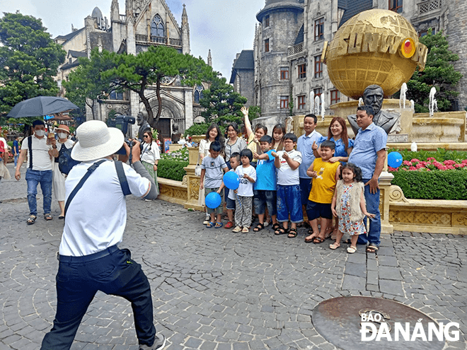 Visitors take souvenir photos to save beautiful moments during their stay at the Sun World Ba Na Hills tourist area.