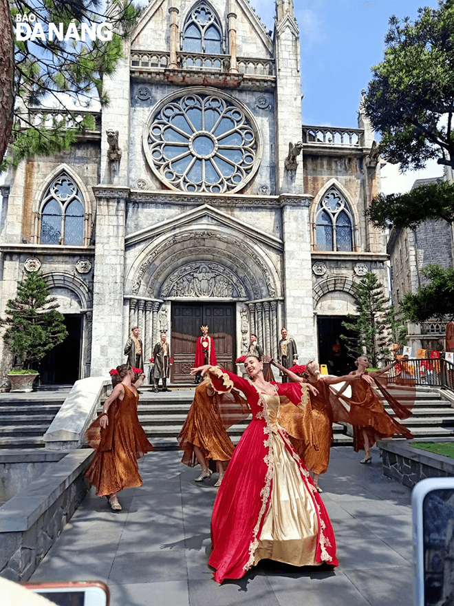 A cultural performance attracts tourists at the Sun World Ba Na Hills tourist area.