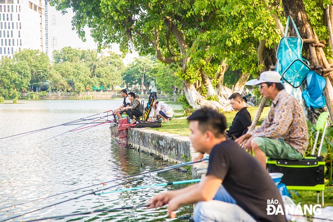 Men are seen going fishing at the March 29 Park during hot and sunny days