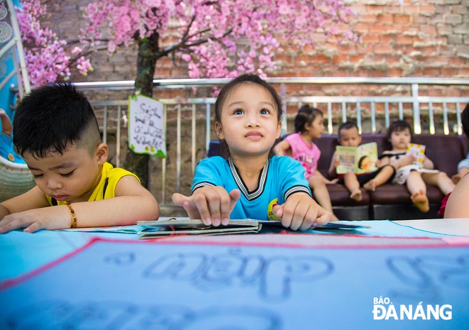 Happiness can be seen through the eyes of a pupil as she practices writing letters in a clean and well-lit space