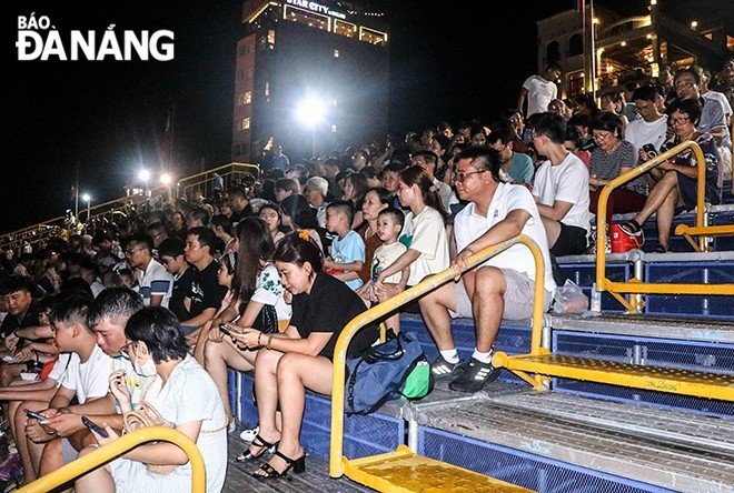 The grandstand area is filled with many residents and visitors.