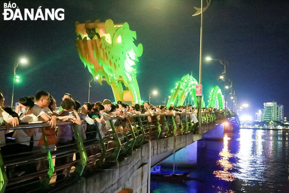  Many residents and visitors watch the fireworks from Dragon Bridge.