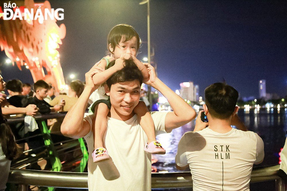 A family enjoys relaxing moment while watching fireworks.