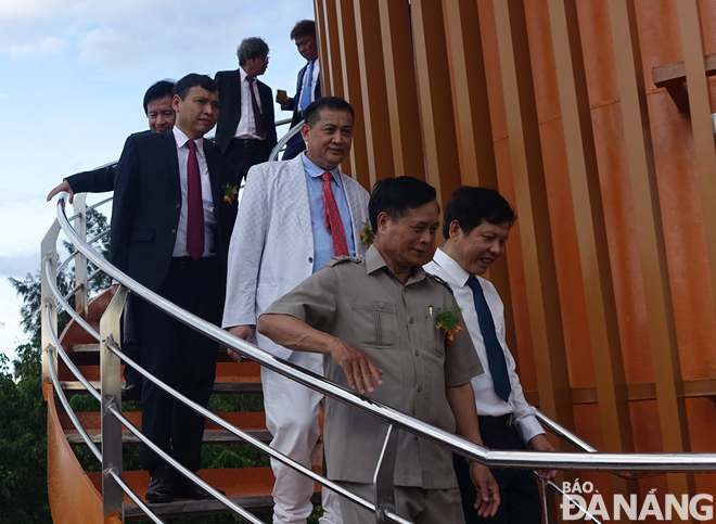 City leaders and guests move from the observation deck to the pedestrian bridge