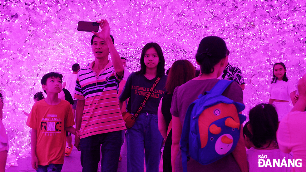 Visitors pose for souvenir photos at the first-ever artistic light space in Da Nang