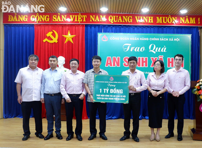 Representatives from Da Nang receive a symbolic board of donations from representatives of VBSP. Photo: M.QUE 