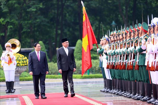 Thủ tướng Phạm Minh Chính và Thủ tướng Malaysia Anwar Ibrahim duyệt Đội danh dự Quân đội nhân dân Việt Nam. Ảnh: Dương Giang/TTXVN