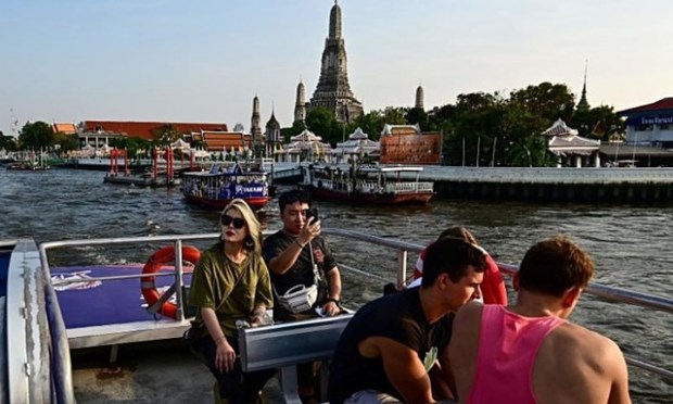 Tourists ride a Hop-on Hop-off cruise boat along the Chao Phraya River in Bangkok. (Photo: AFP/VNA)