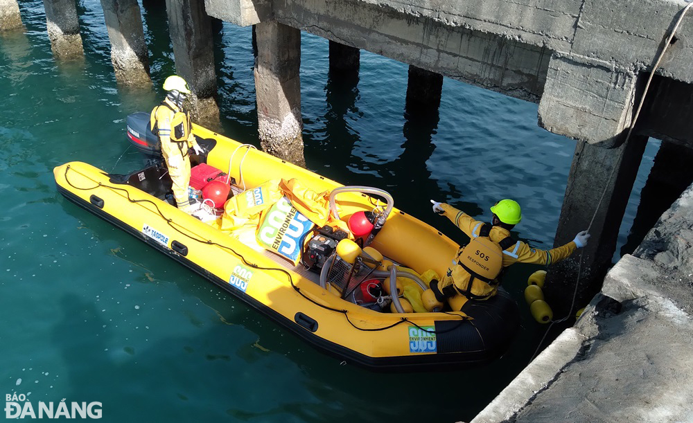 Employees of the Viet Nam Environmental Incident Response Center conduct a drill to pump oil spilled on the sea surface to shore