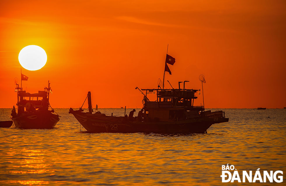 Boats enter Man Thai Beach for the sale of seafood after a night of fishing at sea