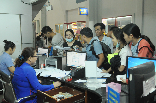 Passengers buying train tickets at the Saigon Railway Station.