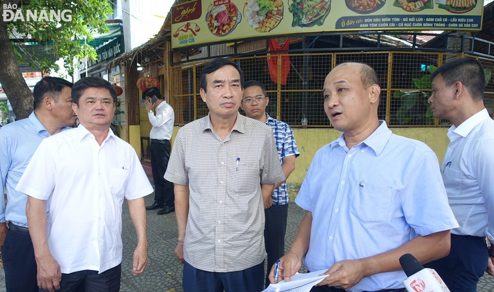 Phó Chủ tịch UBND thành phố Lê Quang Nam (bên phải) chỉ đạo các địa phương, đơn vị nạo vét cửa thu nước mưa bảo đảm thoát nước mặt. Ảnh: HOÀNG HIỆP