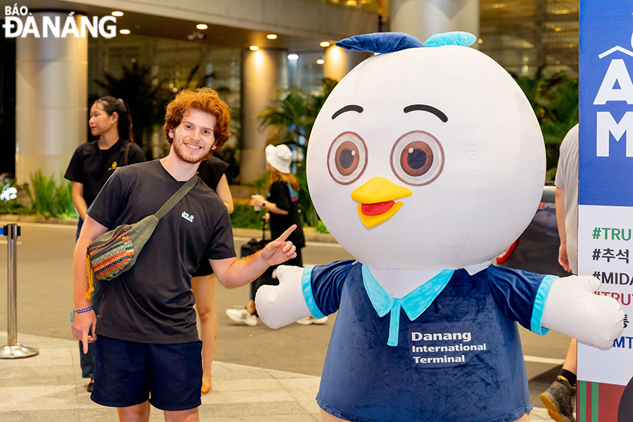 Many tourists enjoy taking photos with a decorative mascot at the terminal