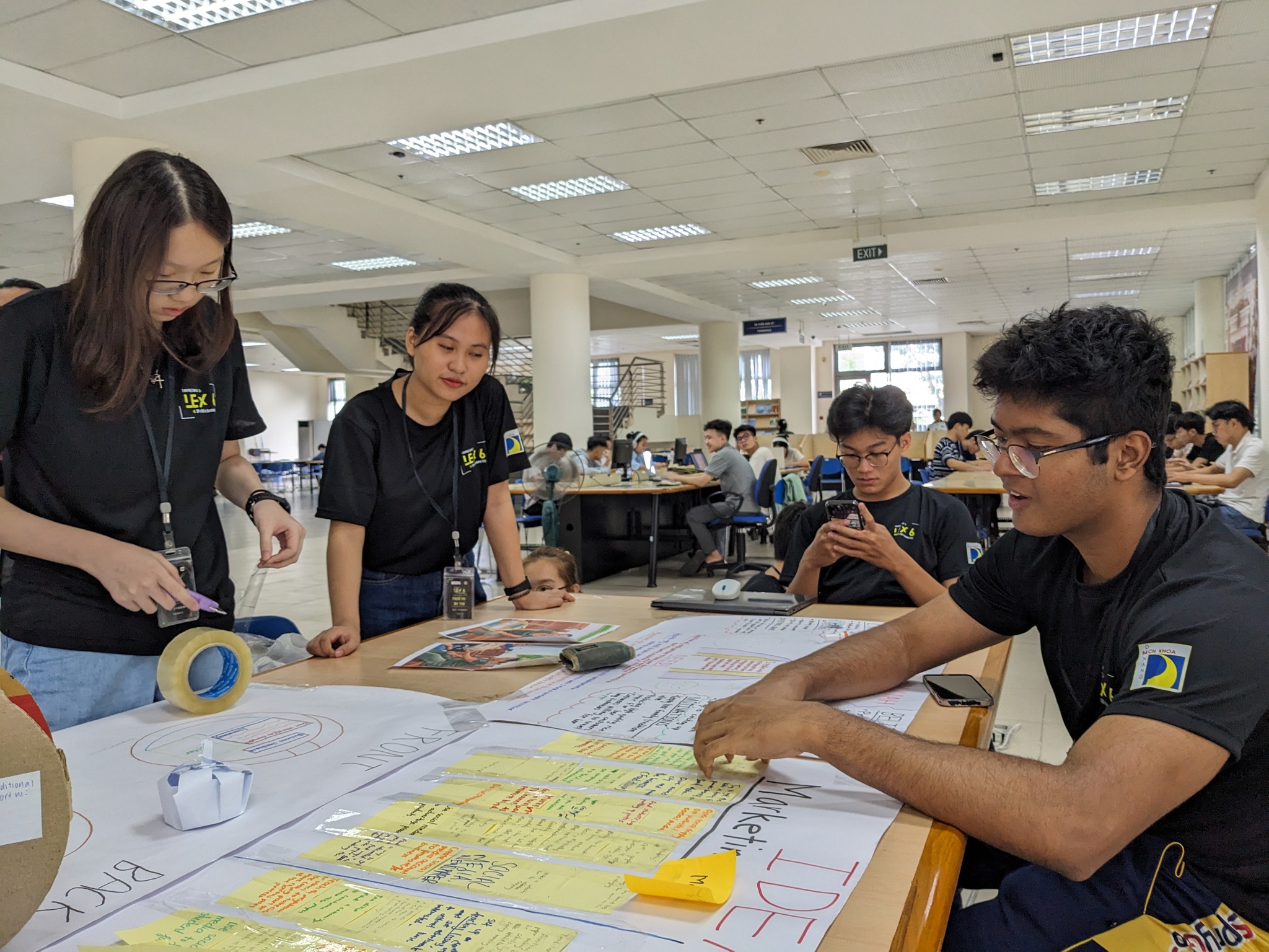 Students who participate in the Learning Express (LeX) programme discuss ways to help promote Tuy Loan rice paper. Photo: HUYNH LE