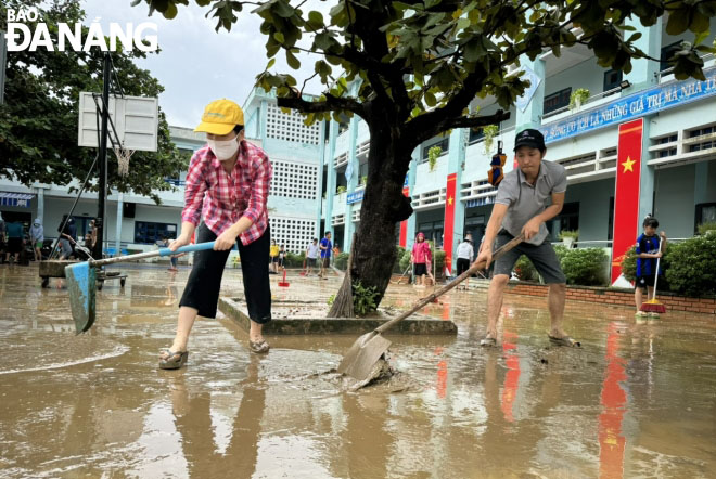 Giáo viên, cán bộ, nhân viên Trường Tiểu học Hồng Quang (quận Liên Chiểu) dọn vệ sinh sân trường đón học sinh đi học trở lại. Ảnh: NGỌC HÀ