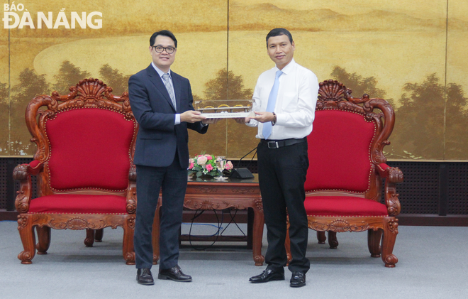 Vice Chairman of the municipal People's Committee Ho Ky Minh (right) presents a souvenir to the VINK representative. Photo: M.Q