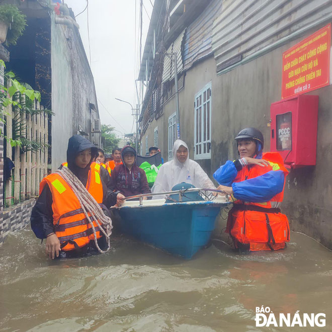 Thanh niên Đoàn phường Hòa Khánh Nam cùng các lực lượng địa phương đưa xuồng ứng cứu người dân bị ngập sâu trên đường Hoàng Văn Thái ngày 14-10-2023. Ảnh: T.Y