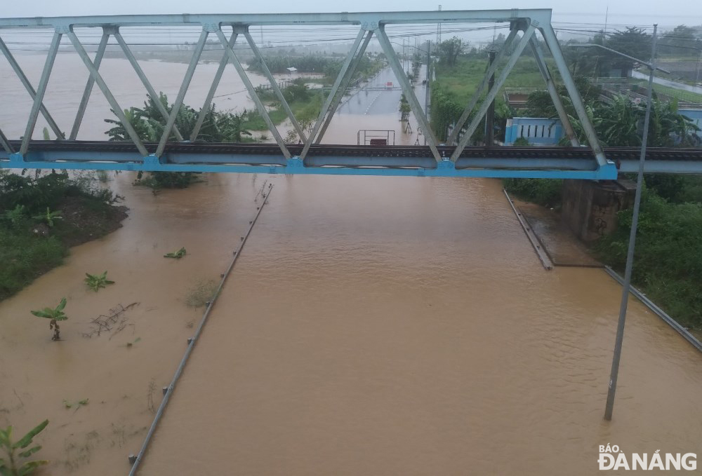 Overflowing river caused flooding in a low-lying section of Thang Long Street.