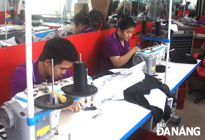 People with disabilities attending a training course in sewing at the Da Nang-based industrial sewing factory for disabled workers. Photo: QUOC CUONG