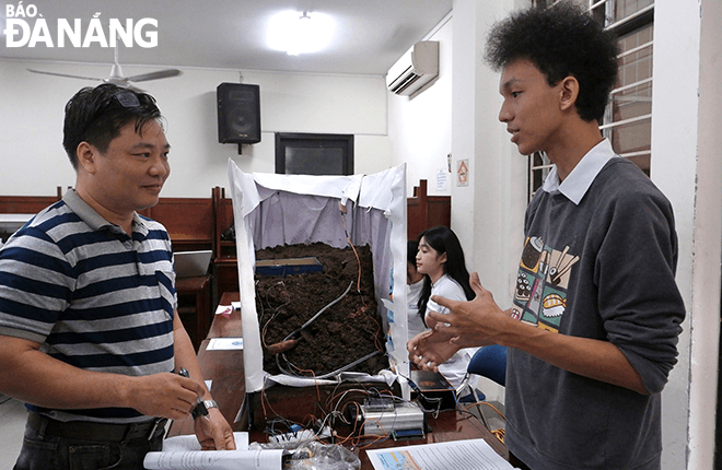 A student ( right) presenting the Smart Water Drainage System to prevent landslides at the school-level Science and Technology Competition for the 2023-2024 academic year held on November 11.