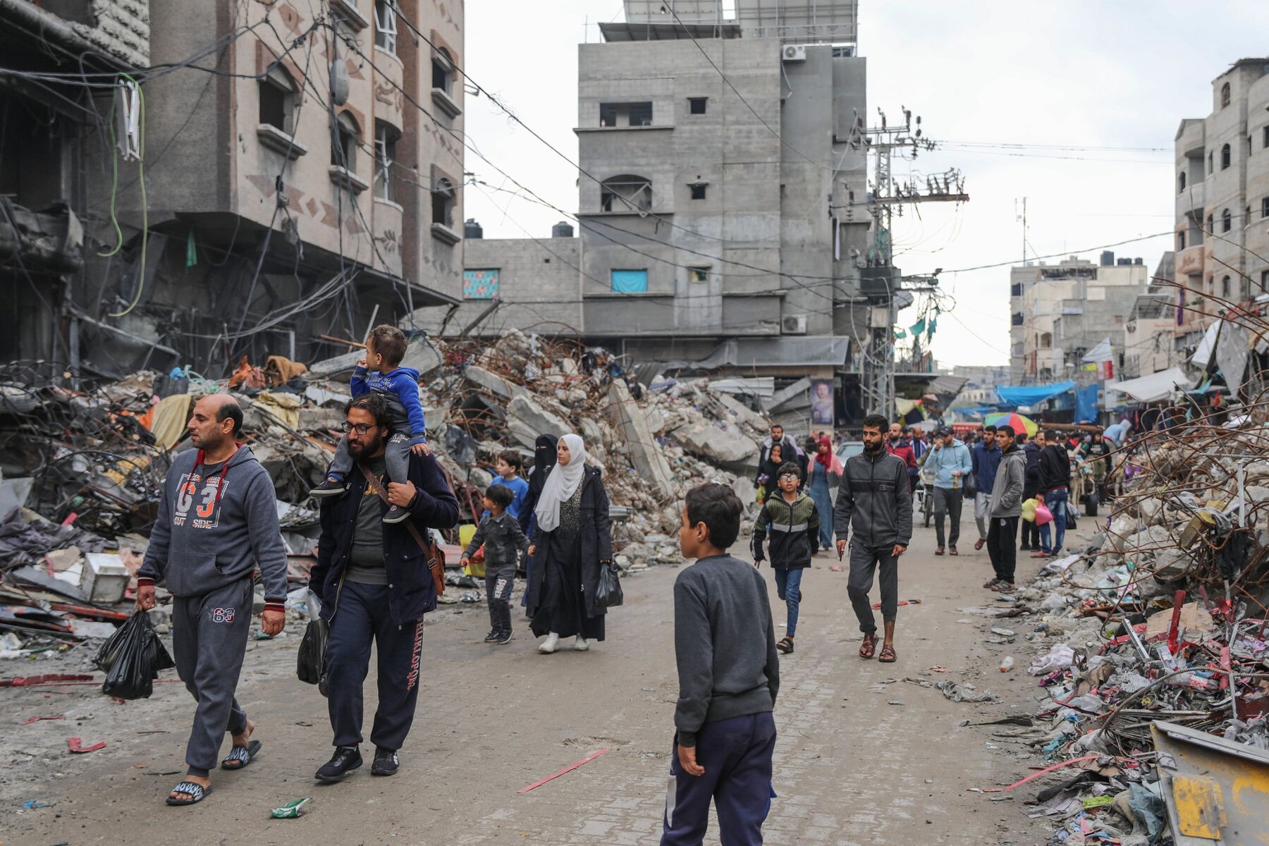 Người Palestine đi qua các tòa nhà bị phá hủy ở trại tị nạn Jabalia, Dải Gaza, vào ngày 28-11. Ảnh: AP