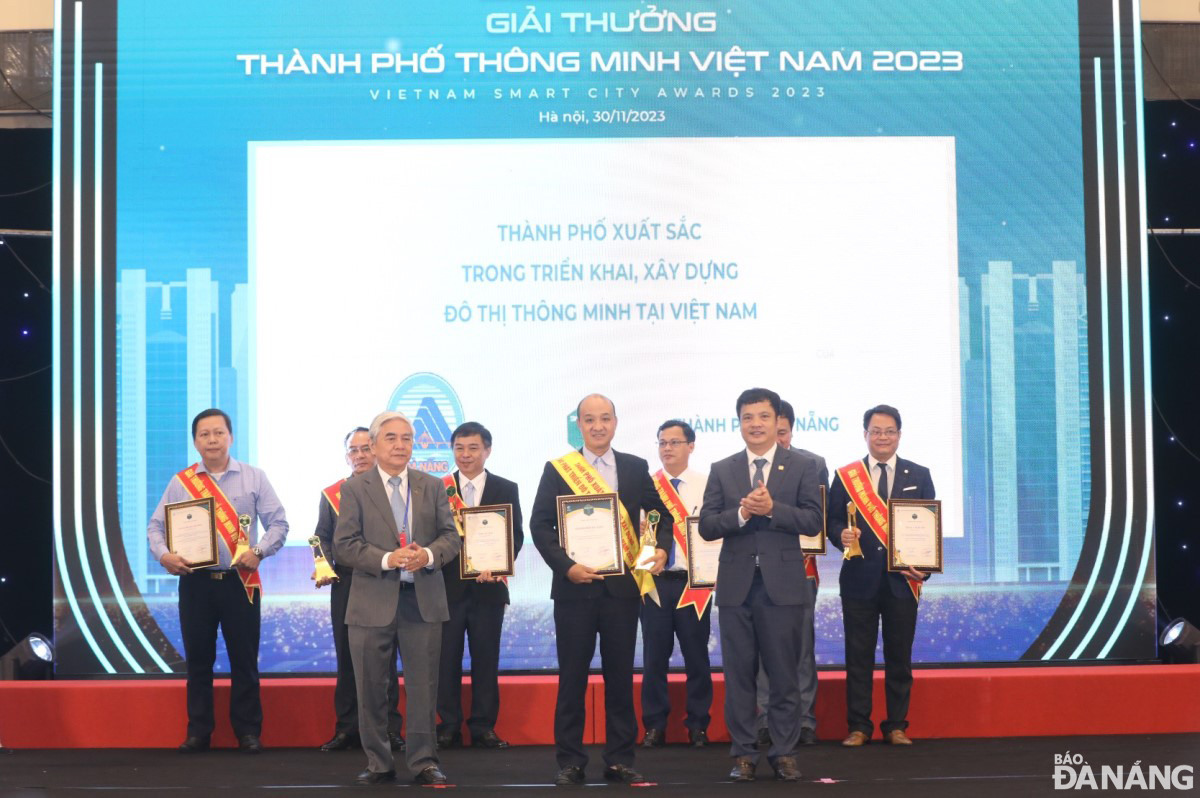 Vice Chairman of the Da Nang People's Committee Le Quang Nam (middle) receives the award for excellence in deploying and building smart urban areas in Viet Nam. Photo: H.H