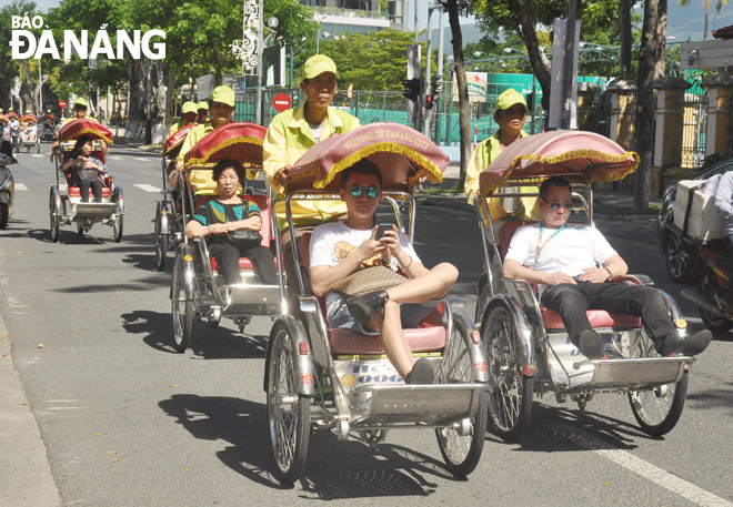 Visitors taking a cyclo tour in Da Nang