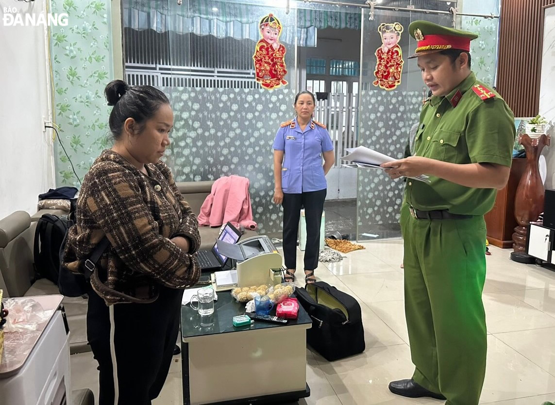 Cơ quan Cảnh sát điều tra (Công an thành phố) tống đạt các quyết định đối với Nguyễn Thị Khánh Vân (ngoài cùng bên trái). Ảnh: L.H.